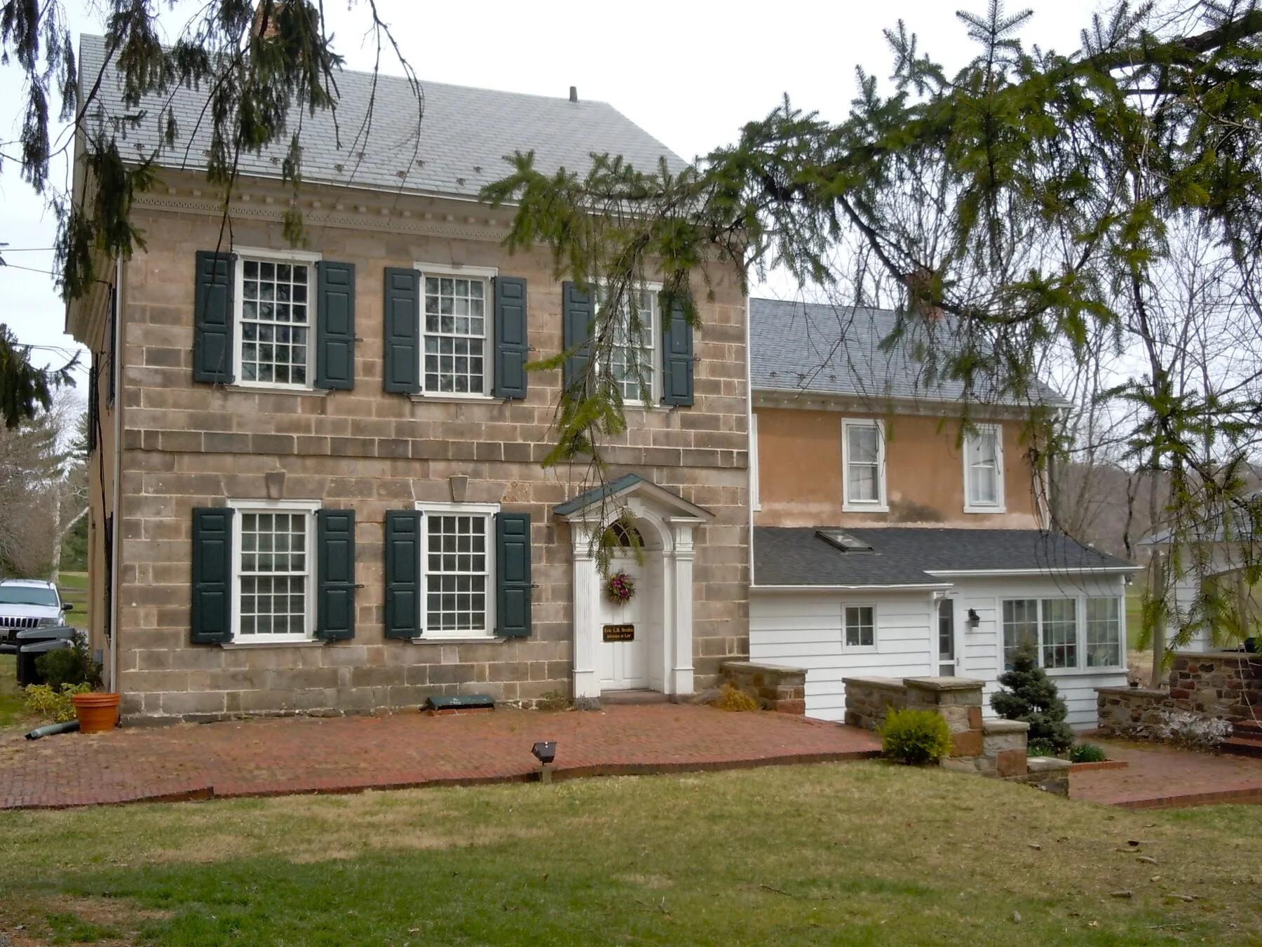 A stone office building with green shutters